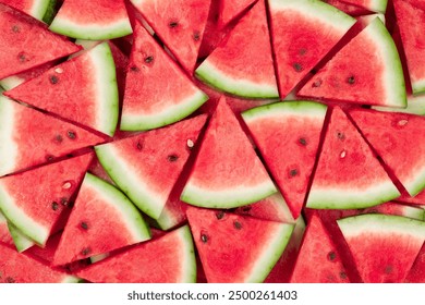 Overhead of Layers of Fresh Sliced Red Watermelon Wedges with Seeds