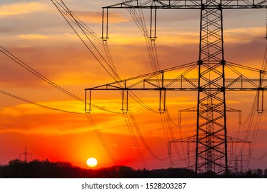 Overhead Line Mast In Front Of The Orange Sky