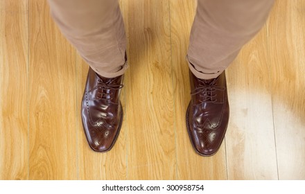 Overhead Of Mans Dress Shoes On Wooden Floor