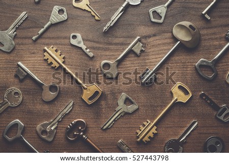 overhead of many different keys in oder on wooden background concept