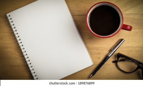 Overhead Of Notepad And Pen And Coffee On A Desk