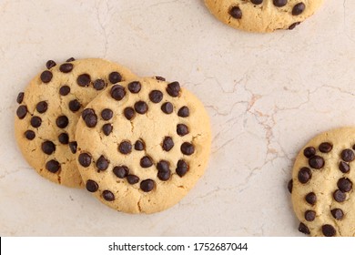 An Overhead Photo Of Chocolate Chips Cookies With A Slice Of Chocolate,With Copy Space