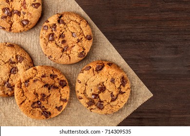 An Overhead Photo Of Chocolate Chips Cookies, Shot From Above On A Piece Of Baking Paper, With Copy Space