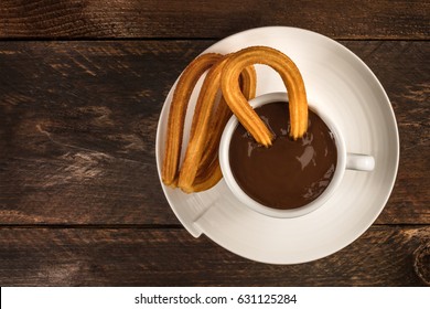 An Overhead Photo Of Churros, Traditional Spanish, Especially Madrid, Dessert, Particularly For Sunday Breakfast, With A Cup Of Hot Chocolate And A Place For Text