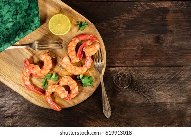 An Overhead Photo Of Cooked Shrimps, A Slice Of Lime, Cilantro Leaves, Salt Flakes, And A Place For Text
