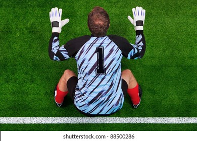 Overhead Photo Of A Football Goalkeeper Standing On The Goal Line In Ready Position To Face A Penalty Kick.