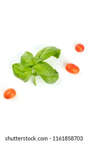 An Overhead Photo Of Fresh Basil With Cherry Tomatoes On A White Background With Copyspace