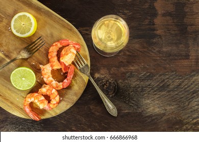 An Overhead Photo Of A Glass Of White Wine With Cooked Shrimps, Slices Of Lime And Lemon, Salt Flakes, And Plenty Of Copy Space