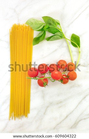 An overhead photo of a letter P for pasta, formed by spaghetti, cherry tomatoes, and a sprig of basil leaves, on a white marble background texture with copy space