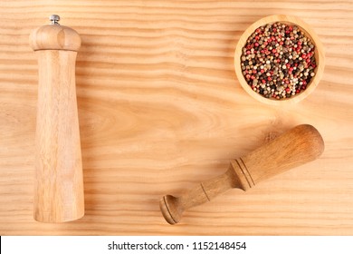 An Overhead Photo Of A Mix Of Various Peppers With A Pepper Mill And A Pestle, Shot From Above On A Wooden Background With Copy Space