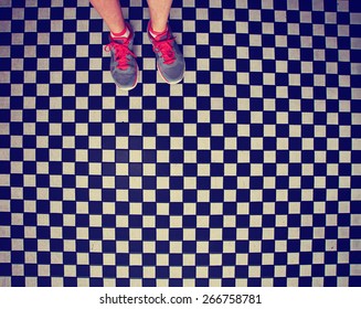 An Overhead Photo Of A Pair Of Tennis Shoes On A Grungy Dirty Checkered Tile Floor Toned With A Retro Vintage Instagram Filter App Or Action