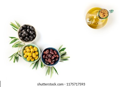 An Overhead Photo Of Various Olives In Bowls With Leaves And A Cruet Of Olive Oil, With Copy Space, On A White Background