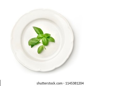 An Overhead Photo Of A White Plate With Fresh Basil Leaves And Copy Space, Shot From Above On A White Background