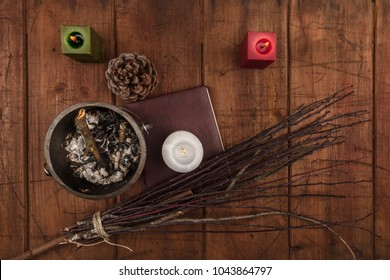 An Overhead Photo Of A Witch's Cauldron, A Grimoire, Candles, A Pine Cone, And A Handmade Broom. Wiccan Ritual Objects, Shot From Above On A Dark Background With A Place For Text