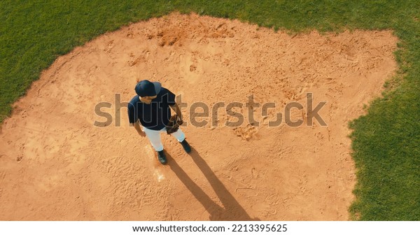 OVERHEAD Pitcher baseball player throws a ball from\
the pitcher\'s mound