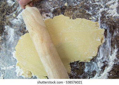 Overhead Of Rolling Out Sugar Cookie Dough To Make Christmas Cookies