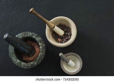 Overhead Of Sea Salt And Black Salt In Mortar Pestle