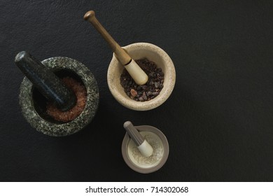 Overhead Of Sea Salt And Black Salt In Mortar Pestle