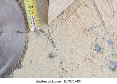 Overhead Of Shop Table; Sawdust, Tape Measure, Wood Block, Saw Blade