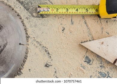 Overhead Of Shop Table; Sawdust, Tape Measure, Wood Block, Saw Blade