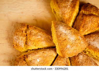 An Overhead Shot Of An Arrangement Of Pumpkin Scones With A Single Scone On Top.