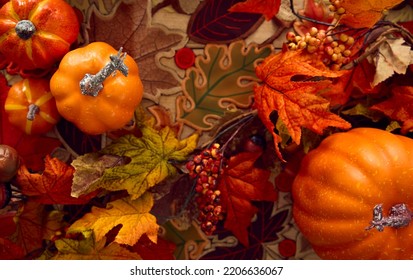 Overhead Shot Of Autumn Or Fall Table Decoration At Home With Pumpkins And Leaves