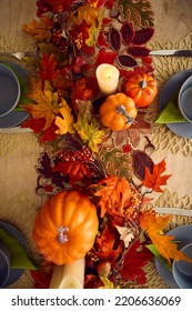 Overhead Shot Of Autumn Or Fall Table Decoration At Home With Pumpkins And Leaves