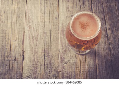 Overhead Shot Of Beer Glass On An Old Wooden Table