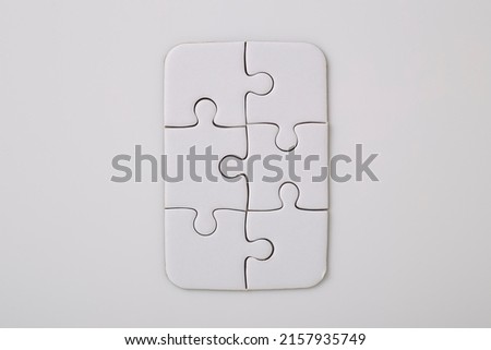 Overhead shot of blank six white puzzle pieces on a white background Merging different elements into a whole