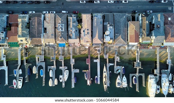 An overhead shot\
of boat docks and houses.