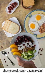 An Overhead Shot Of A Breakfast Spread Composed Of Eggs, Fruits, Bread, Biscuits And Sausage