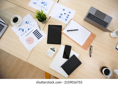 Overhead Shot, Business Meeting Table Or Conference Table With Laptop Computer, Tablet, Business Report And Accessories.