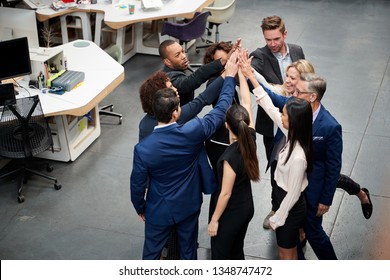 Overhead Shot Of Business Team Celebrating Success With Champagne Toast In Modern Office