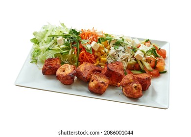 Overhead  shot of Chicken Tikka Brochette on white plate. Isolated on white with clipping path