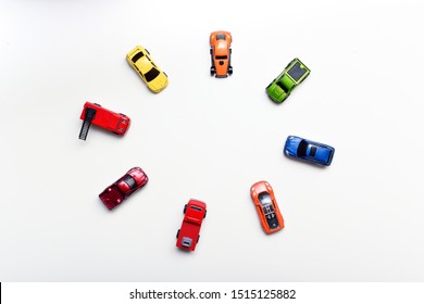 Overhead Shot Of Child's Toy Cars Arranged On A White Table, No People In Shot