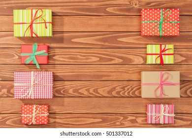 Overhead shot of christmas presents on wooden table - Powered by Shutterstock