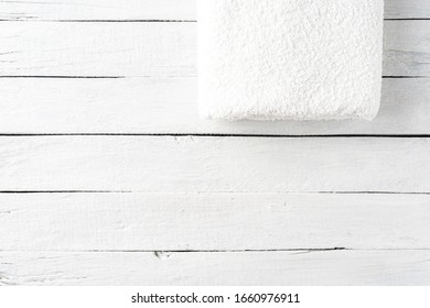 Overhead Shot Of Clean Folded Towel On White Wooden Table With Copyspac