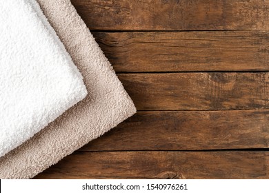 Overhead Shot Of Clean Folded Towels On Rustic Wooden Table With Copyspace