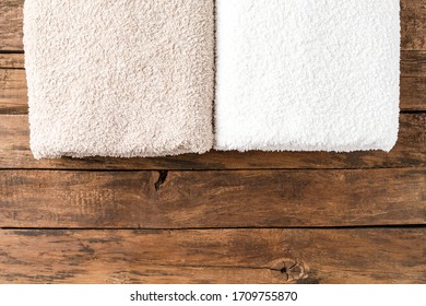 Overhead Shot Of Clean Folded Towels On Rustic Wooden Table With Copyspace