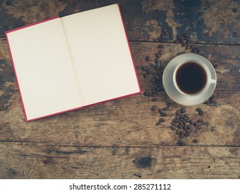 Overhead Shot Of Coffee Concept With Empty Cup, Tea Towel And An Open Book With Blank Pages