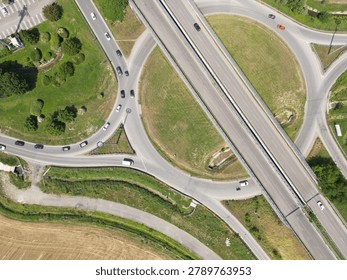 Overhead shot of a complex road junction surrounded by greenery and urban landscape