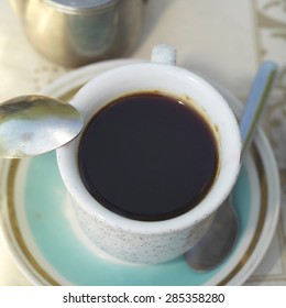 Overhead Shot Of A Cup Of Instant Coffee On A Blue Plate