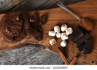 Overhead Shot Of A Cutting Board With Chocolate Chunks Cinnamon Sticks And Cookies. 