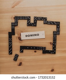 An Overhead Shot Of A Domino Sign And Dominoes On The Table