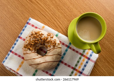 Overhead Shot Of Doughnut And Coffee In Green Mug On Table