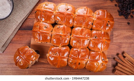 An Overhead Shot Of Freshly Baked Hot Cross Buns On A Wooden Table In A Kitchen