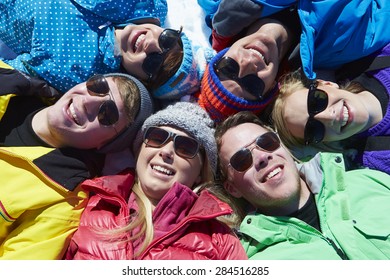 Overhead Shot Of Friends Having Fun On Winter Holiday