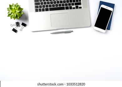 Overhead shot of laptop and accessories on white background with copy space