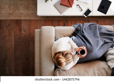 Overhead Shot Looking Down On Woman At Home Lying On Sofa Watching Television - Shutterstock ID 1442875796