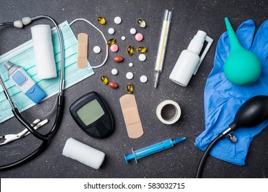 Overhead shot of medical equipment on dark stone background
